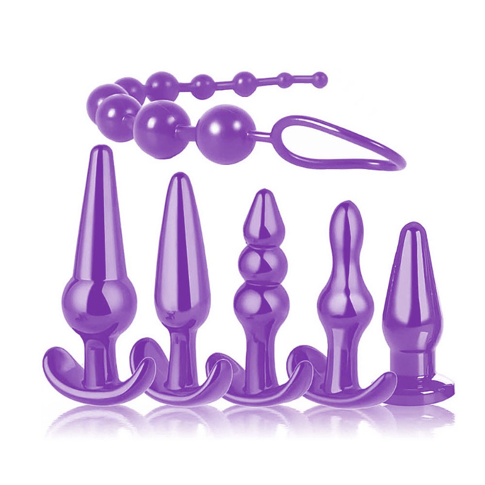 Cinco plugs anais roxos de diferentes tamanhos e formatos (cones e espirais) alinhados, ao lado de um anal beads tamb�m roxo, sobre um fundo branco