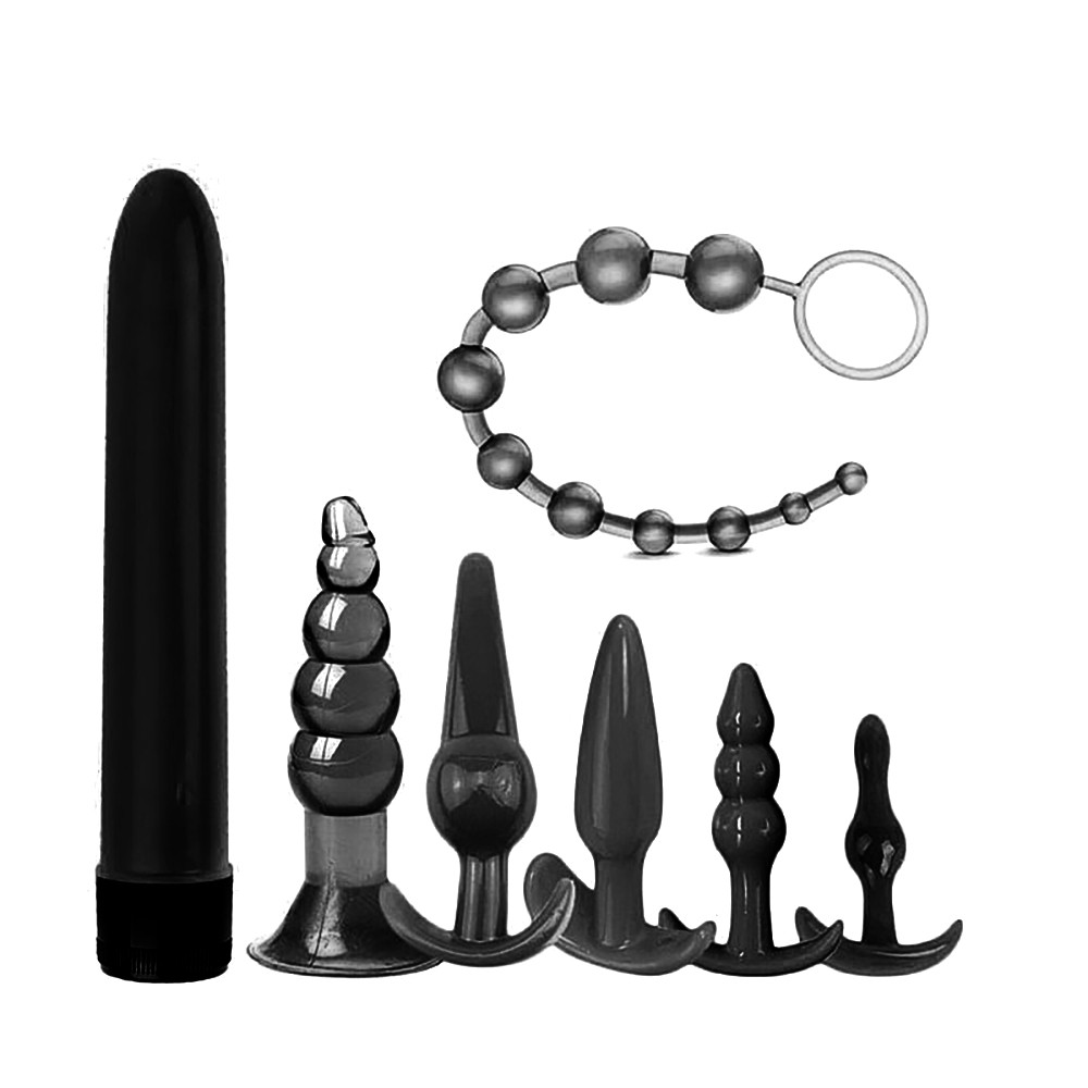 Kit Plug Anal com 6 plugs em TPE preto e 1 vibrador bala, exibindo a variedade de formatos e o colar de p�rolas
