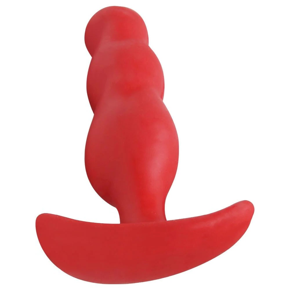 Plug Anal Mini Vermelho de silicone com corpo ondulado e base em T, em um ambiente sensual com luzes de neon