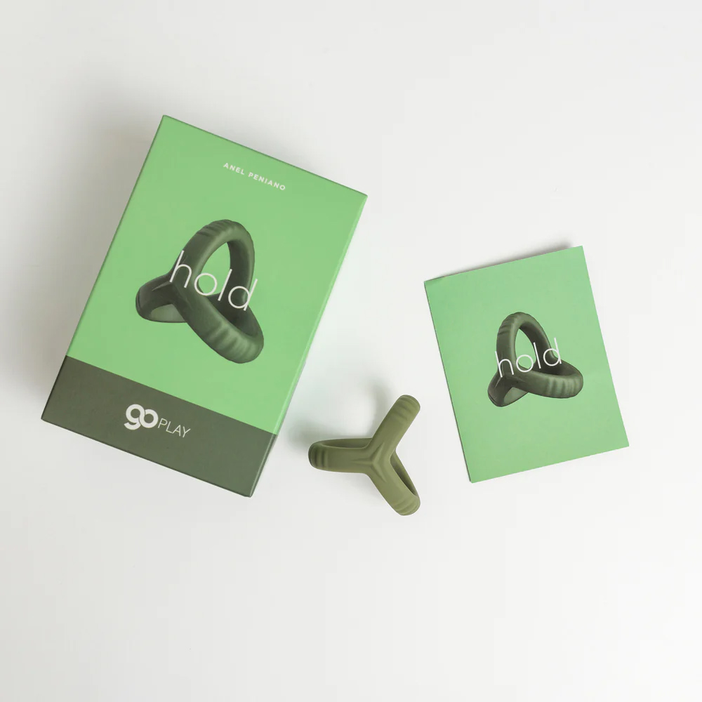 Anel peniano e escrotal Hold em silicone verde militar com a embalagem e o manual, vista de cima