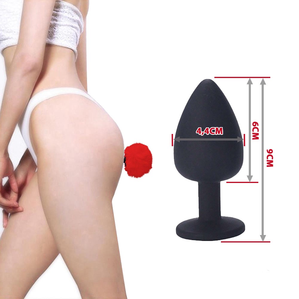 Plug anal de silicone preto com pompom de coelho vermelho, vis�o macro do toque aveludado do silicone
