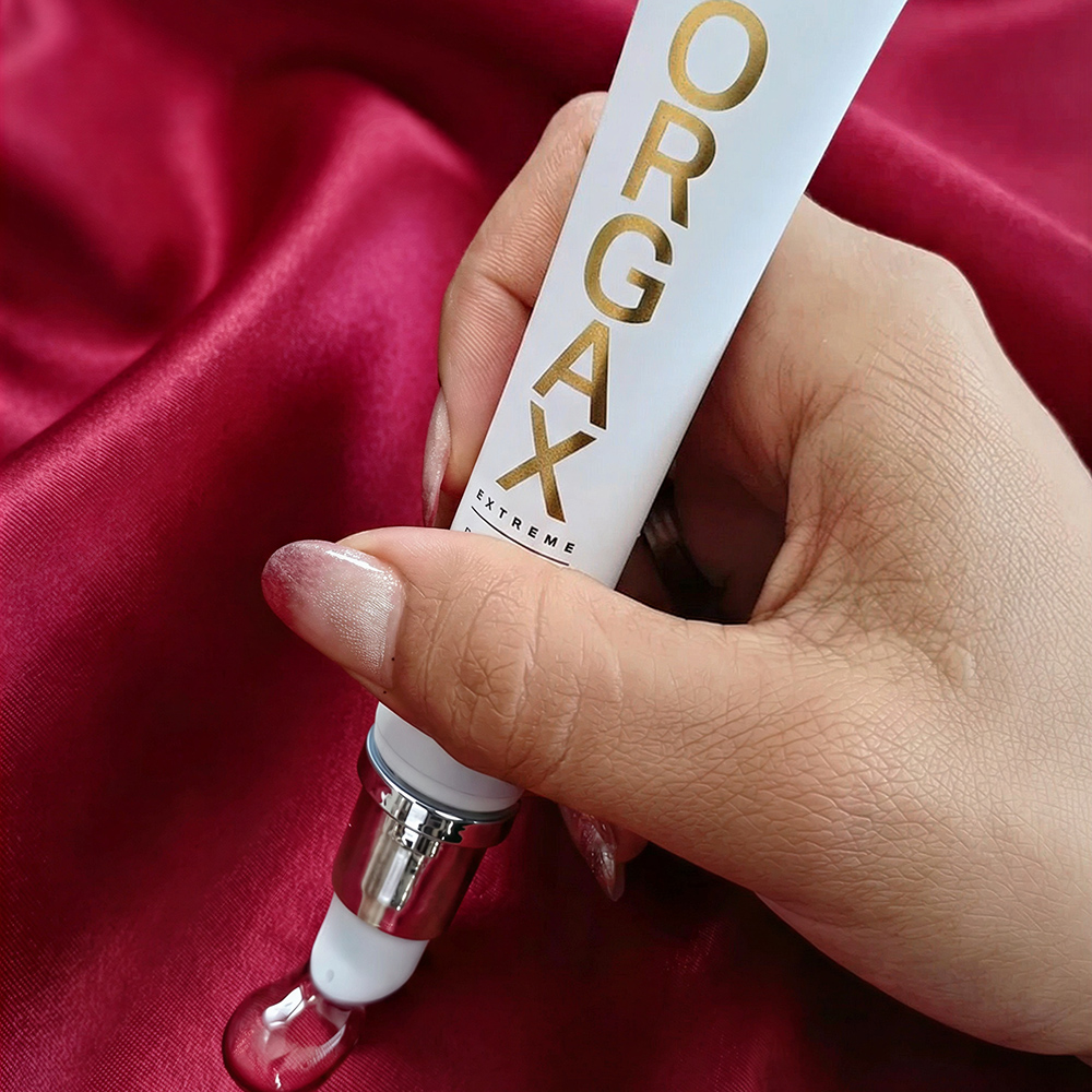 Gel Excitante Feminino Orgax 4 em 1, aplica��o do gel na m�o sobre tecido de seda vermelho