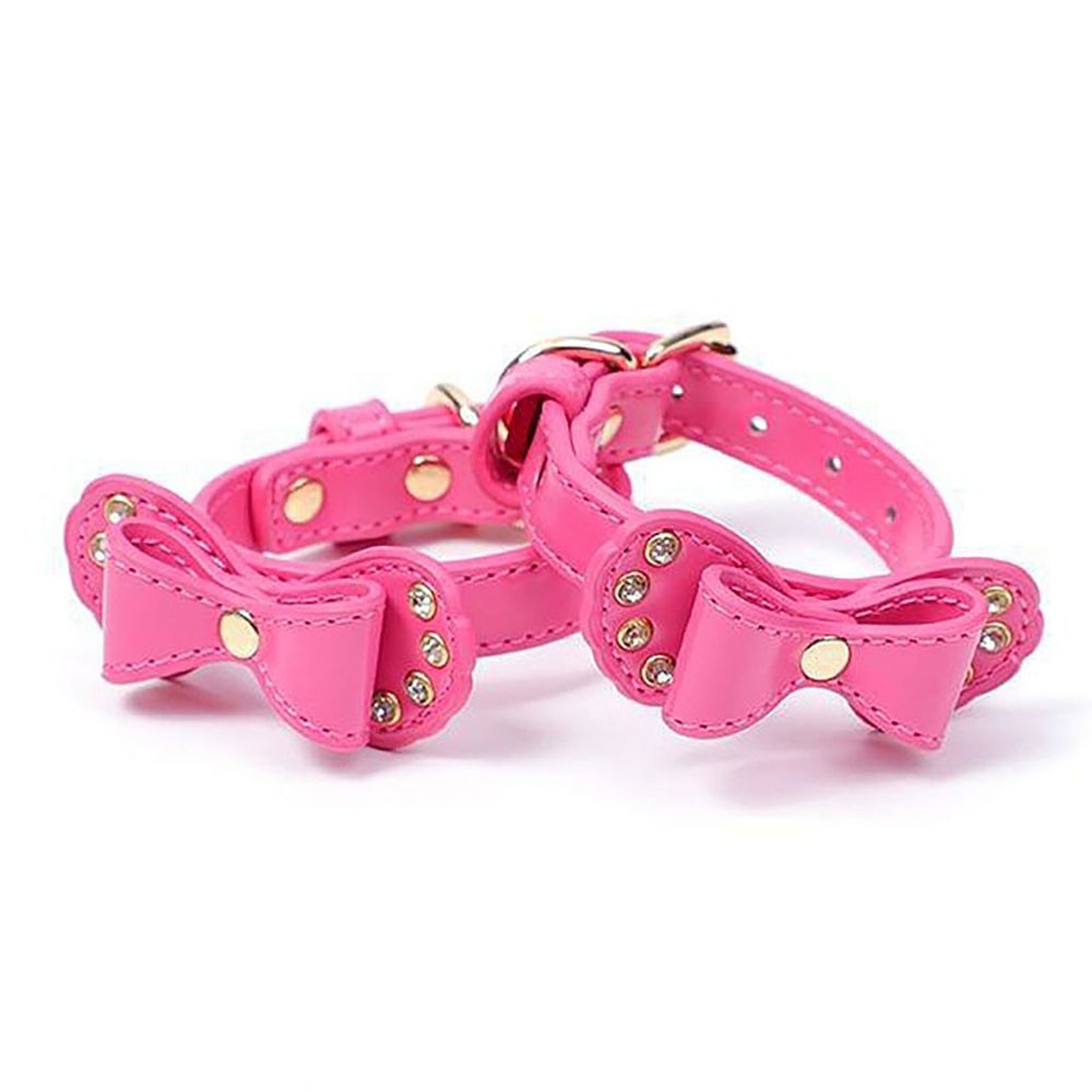 Algemas BDSM rosa em PU com detalhes de gravata borboleta e strass, vistas lateralmente